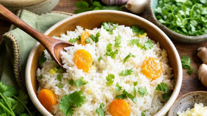 This Garlic and Ginger Rice dish is flavored with the Asian Chicken Stock. The rice stands for 10 minutes so the grains separate and the cilantro flavor permeates the dish. The rice is rinsed three times to get rid of some starch so it won't be sticky when cooked.