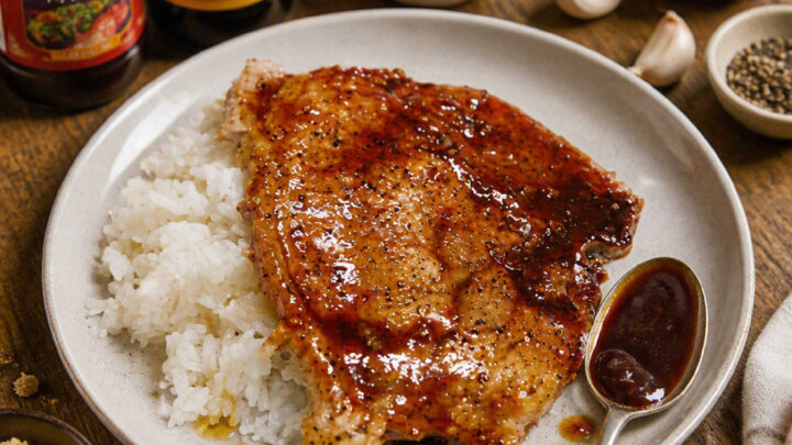 This recipe features grilled boneless pork chops brushed with a homemade hoisin-molasses barbecue sauce and served over hot cooked white rice. The sauce is created by simmering sugar, molasses, hoisin, rice vinegar, soy sauce, and garlic until thickened.