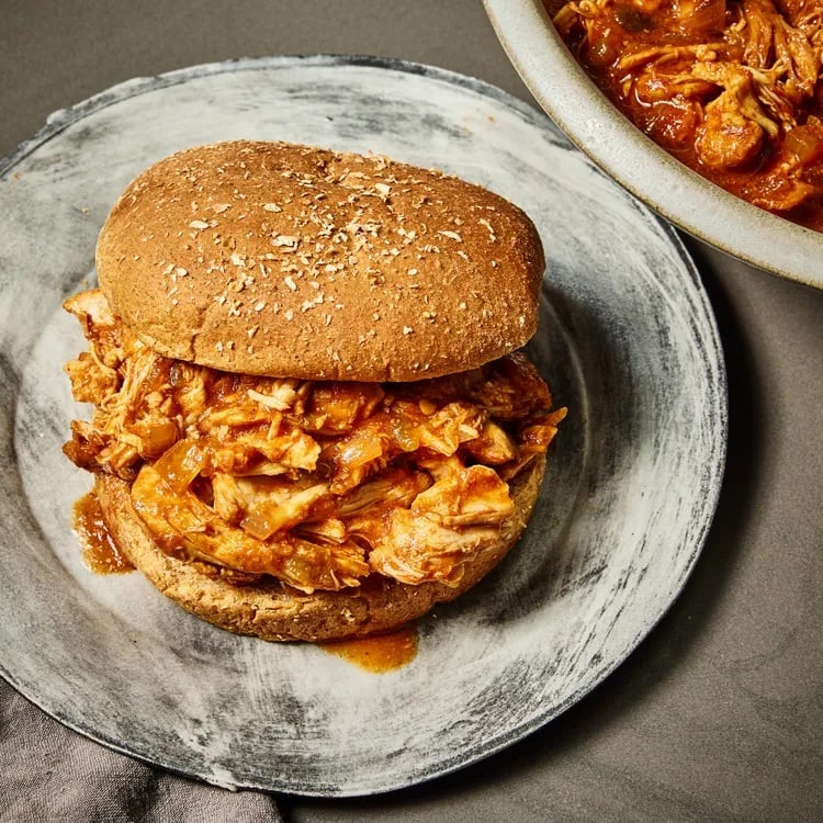 A tangy and tender barbecue pulled chicken sandwich served with creamy coleslaw. A flavorful, comforting meal perfect for weeknights or summer gatherings. #BBQSeason #PulledChicken #ComfortFood #SummerEats #FoodBloggers #HomeCooking #SandwichLove #FarmersMarketWeek