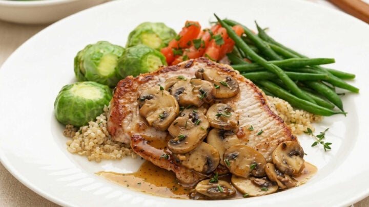 Looking for an effortless yet elegant weeknight meal? These perfectly seared pork chops are smothered in a deeply savory, velvety reduction of earthy wild mushrooms and fragrant thyme. #HomeCooking #PorkChops #ComfortFoodCraft #SkilletDinner #MushroomReduction #EasyRecipes #WeeknightDinner #CozyCooking #DinnerInspiration