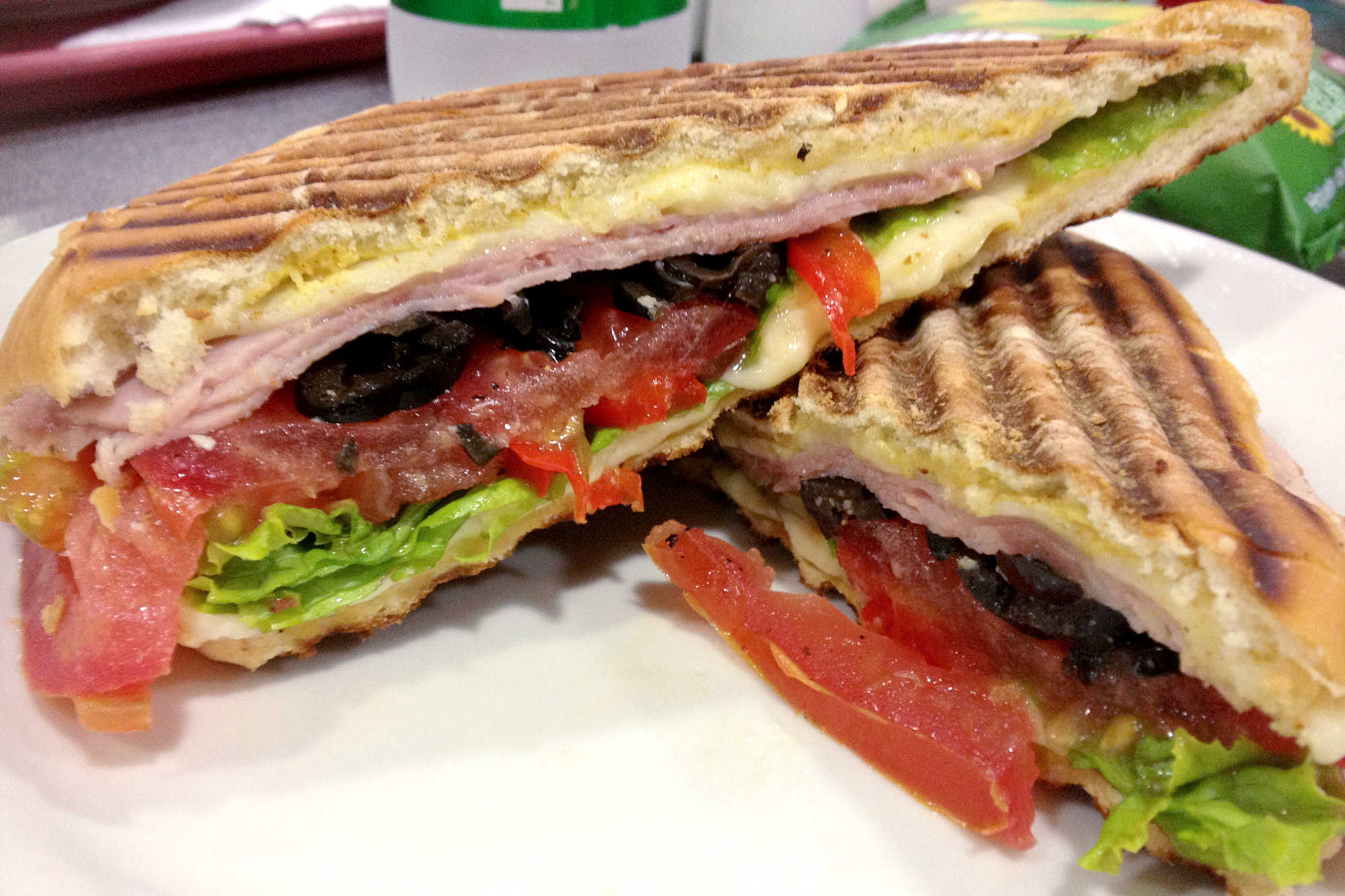 Pressed panini with turkey vegetables, and cheeses.