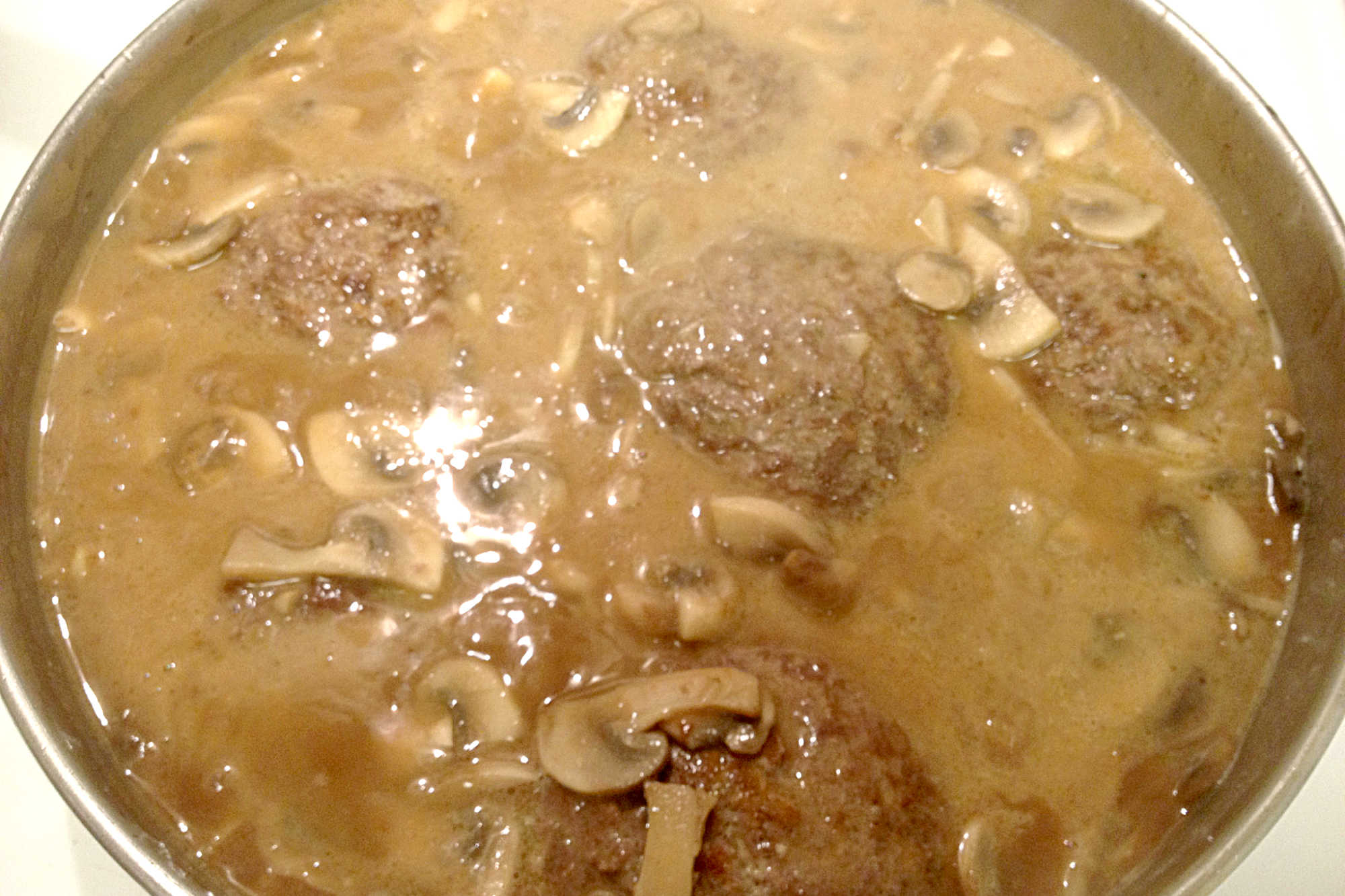 Experience the rich flavors of Hot Hamburger (Salisbury Steak) with this simple and satisfying dish. Each patty is cooked to perfection and topped with flavorful gravy, making it ideal for quick weeknight meals or special occasions. #BurgerMonth #HotHamburger #SalisburySteak #ComfortFoodie #FoodieFaves #MeatloversUnite