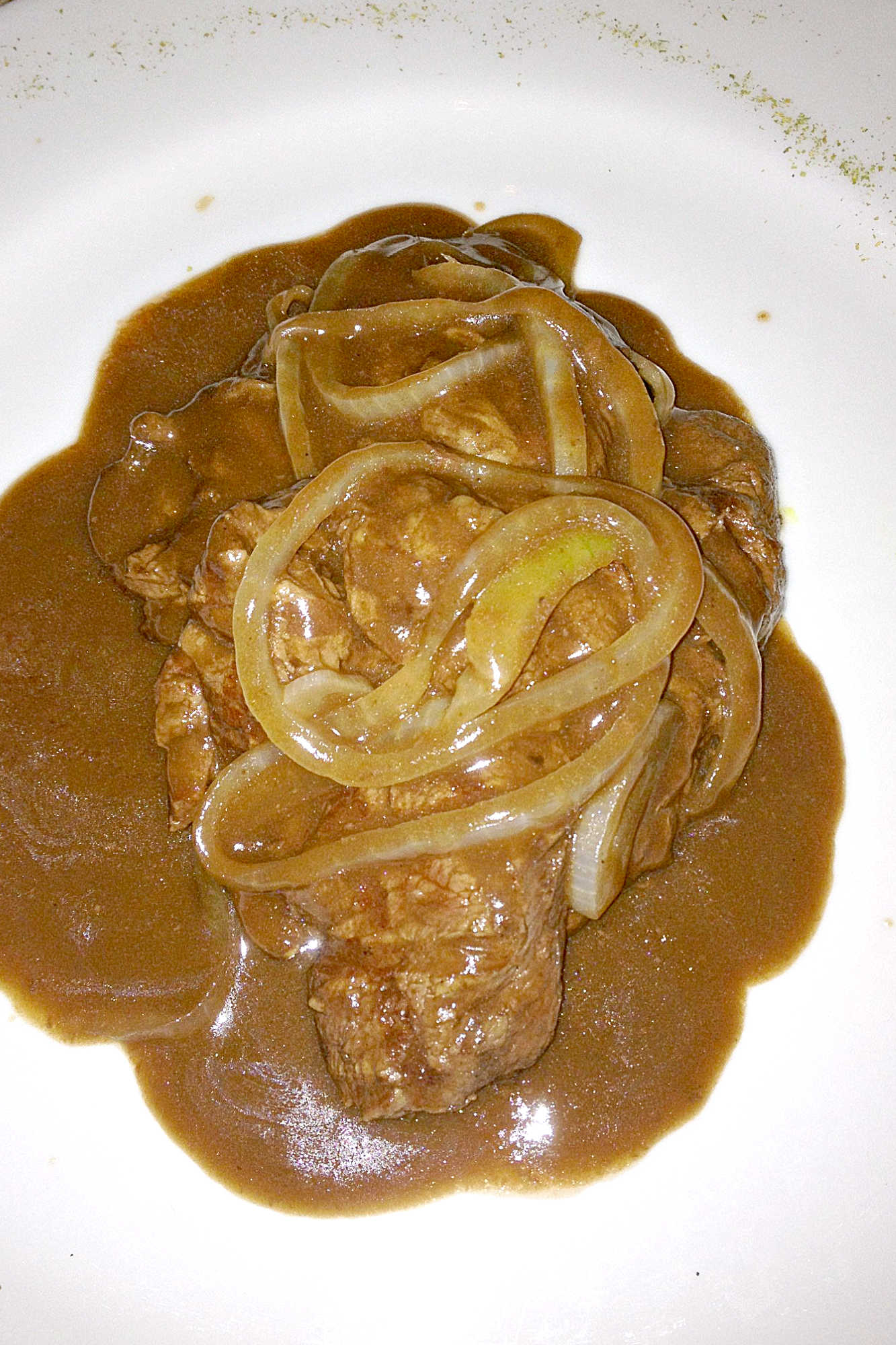 Lomo Saltado, steak with onions in gravy