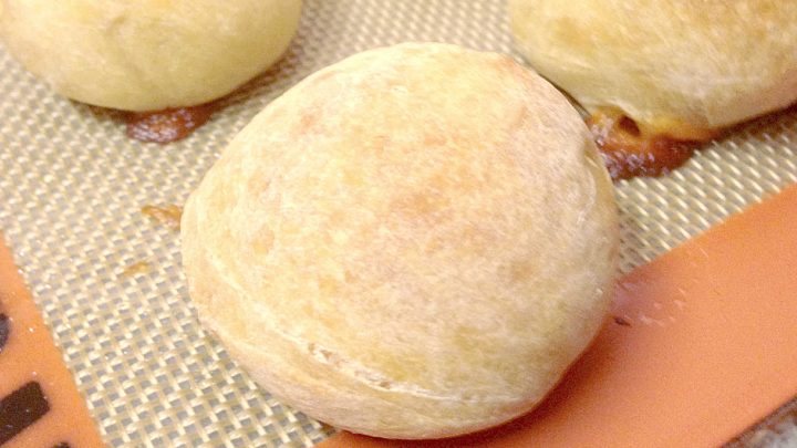 These Mozzarella Stuffed Wheat Rolls are soft, wholesome, and feature the best gooey mozzarella pull. Perfect with soup or as an appetizer! #mozzarellarolls #wholewheat #homemaderolls #bakingrecipe #foodblogger #cheesepull