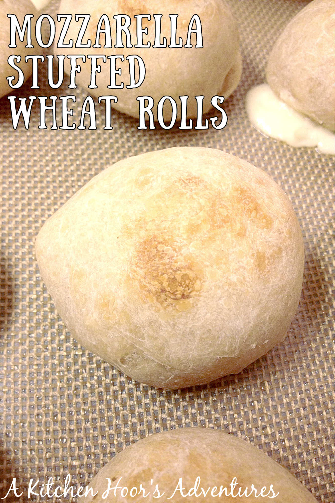 These Mozzarella Stuffed Wheat Rolls are soft, wholesome, and feature the best gooey mozzarella pull. Perfect with soup or as an appetizer! #mozzarellarolls #wholewheat #homemaderolls #bakingrecipe #foodblogger #cheesepull