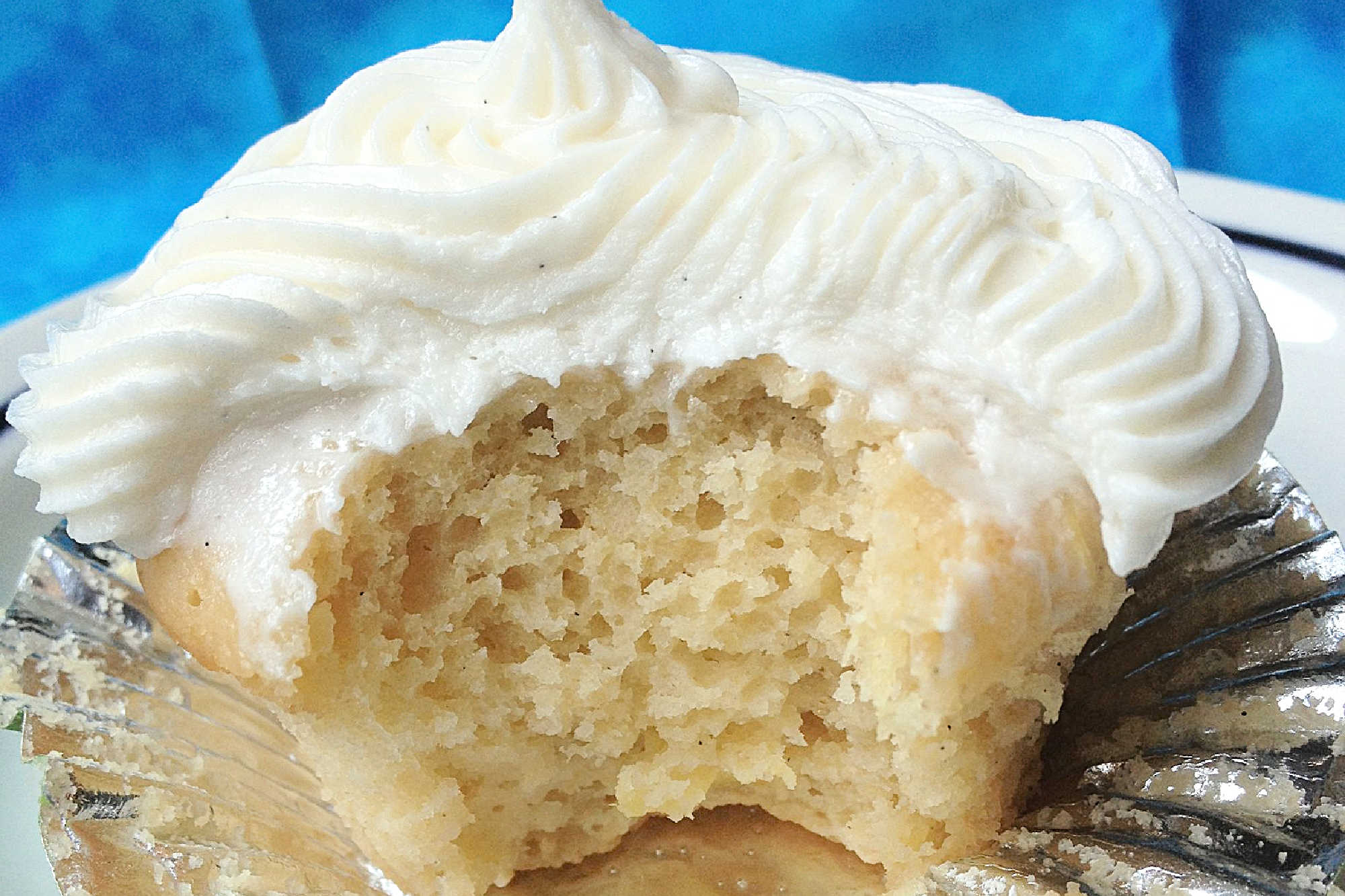 Can't make it to a tropical beach this summer? Bring the flavors of paradise to your kitchen with these delicious Pina Colada Cupcakes! #pineappleparadise #cupcakelove #tropicaltreats #coconutcravings #boozybites