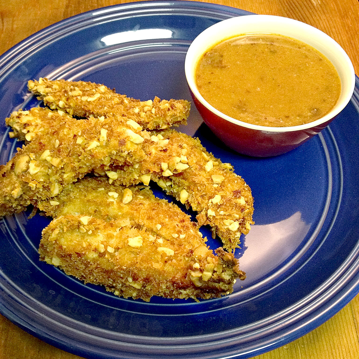 Hands down.  This combination of toasted panko and peanuts is crunchy.  It's very crunchy.  It's crazy tasty crunchy!  Which makes these Crunchy Crusted Chicken Strips with Chipotle Honey Mustard super tasty crazy crunchy.