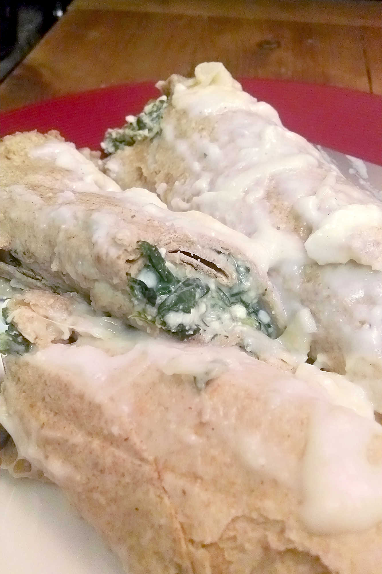 Meet your new favorite twist on comfort food. These Spinach Florentine Enchiladas are rolled just like manicotti and filled with a creamy spinach and cheese blend that will keep you coming back for more. #SpinachFlorentineEnchiladas #MeatlessMonday #VegetarianEats #HealthyComfortFood #EnchiladaRecipeOfTheDay