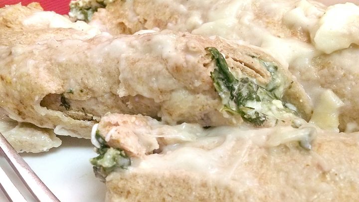 Meet your new favorite twist on comfort food. These Spinach Florentine Enchiladas are rolled just like manicotti and filled with a creamy spinach and cheese blend that will keep you coming back for more. #SpinachFlorentineEnchiladas #MeatlessMonday #VegetarianEats #HealthyComfortFood #EnchiladaRecipeOfTheDay