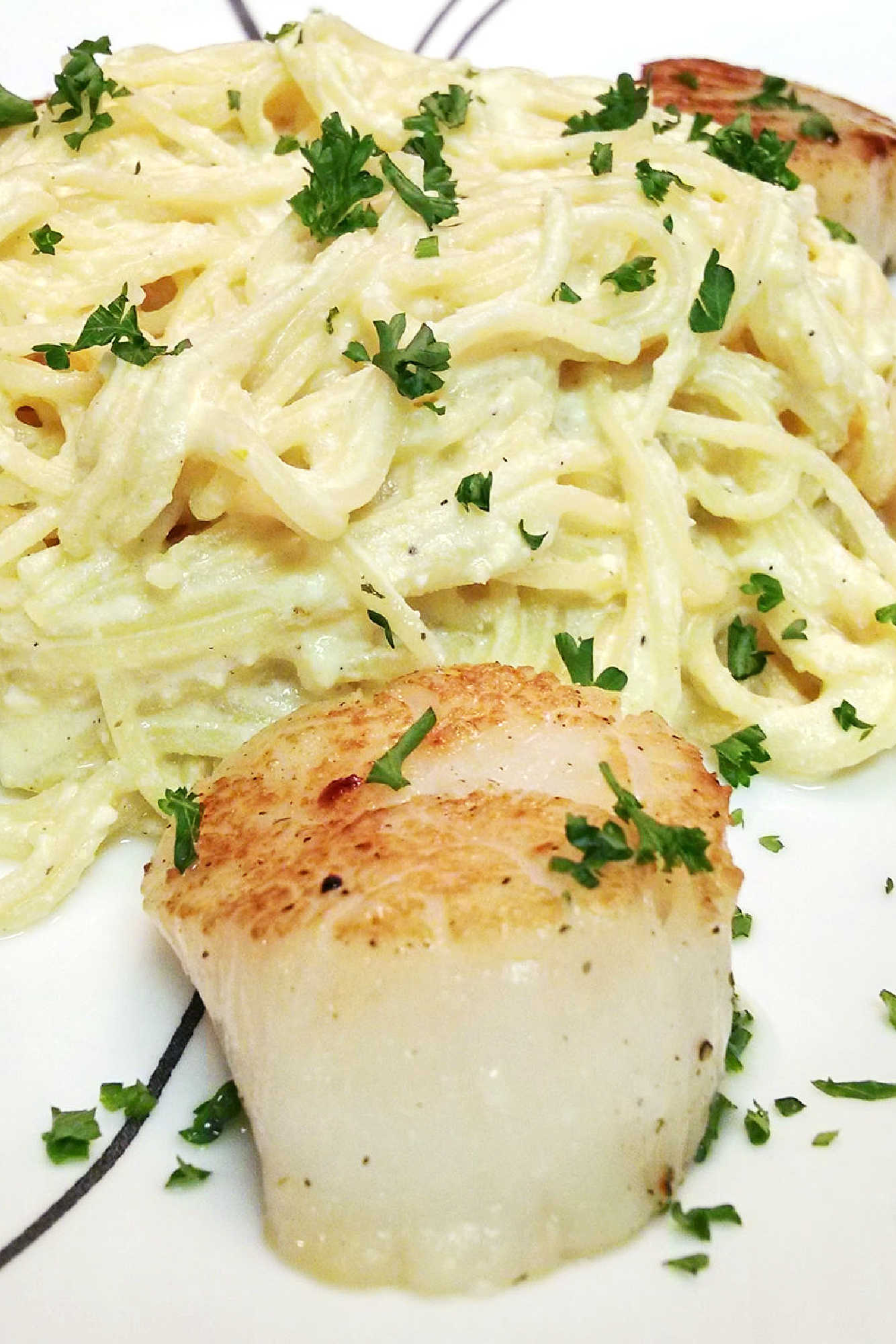 Ricotta Carbonara with seared scallops is the perfect marriage of flavors.  The succulently sweet scallops and the creamy carbonara are a heavenly combination of flavors. #RicottaCarbonara #Scallops #FoodieHeaven #Scallops #LuxuryEats #RicottaCarbonara #ScallopsTwoWays #PastaPerfection #SeafoodLoversUnite #HomemadeDinnerDelights