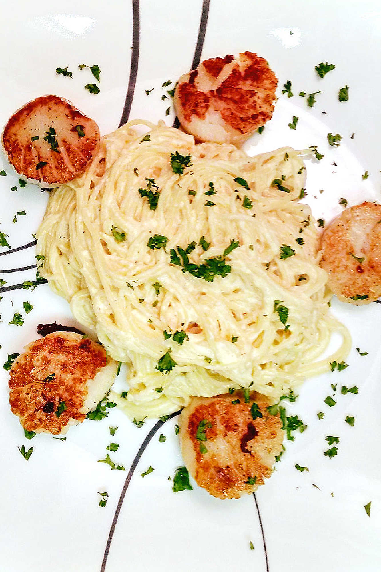 Ricotta Carbonara with seared scallops is the perfect marriage of flavors.  The succulently sweet scallops and the creamy carbonara are a heavenly combination of flavors. #RicottaCarbonara #Scallops #FoodieHeaven #Scallops #LuxuryEats #RicottaCarbonara #ScallopsTwoWays #PastaPerfection #SeafoodLoversUnite #HomemadeDinnerDelights