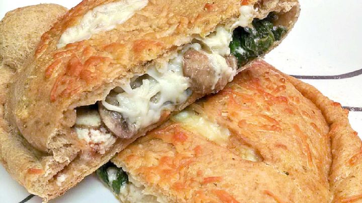 Spinach Mushroom Ricotta Calzones are a delicious and healthy twist on the classic Italian dish. Perfect for a cozy night in or a family dinner (and sneaking in veggies). #weeknightdinner #calzones #easyrecipe #pizzanight #calzones #homemade #ItalianComfortFood #HomemadeBread #VegetarianEats #RicottaCheeseLove #MeatlessMondays