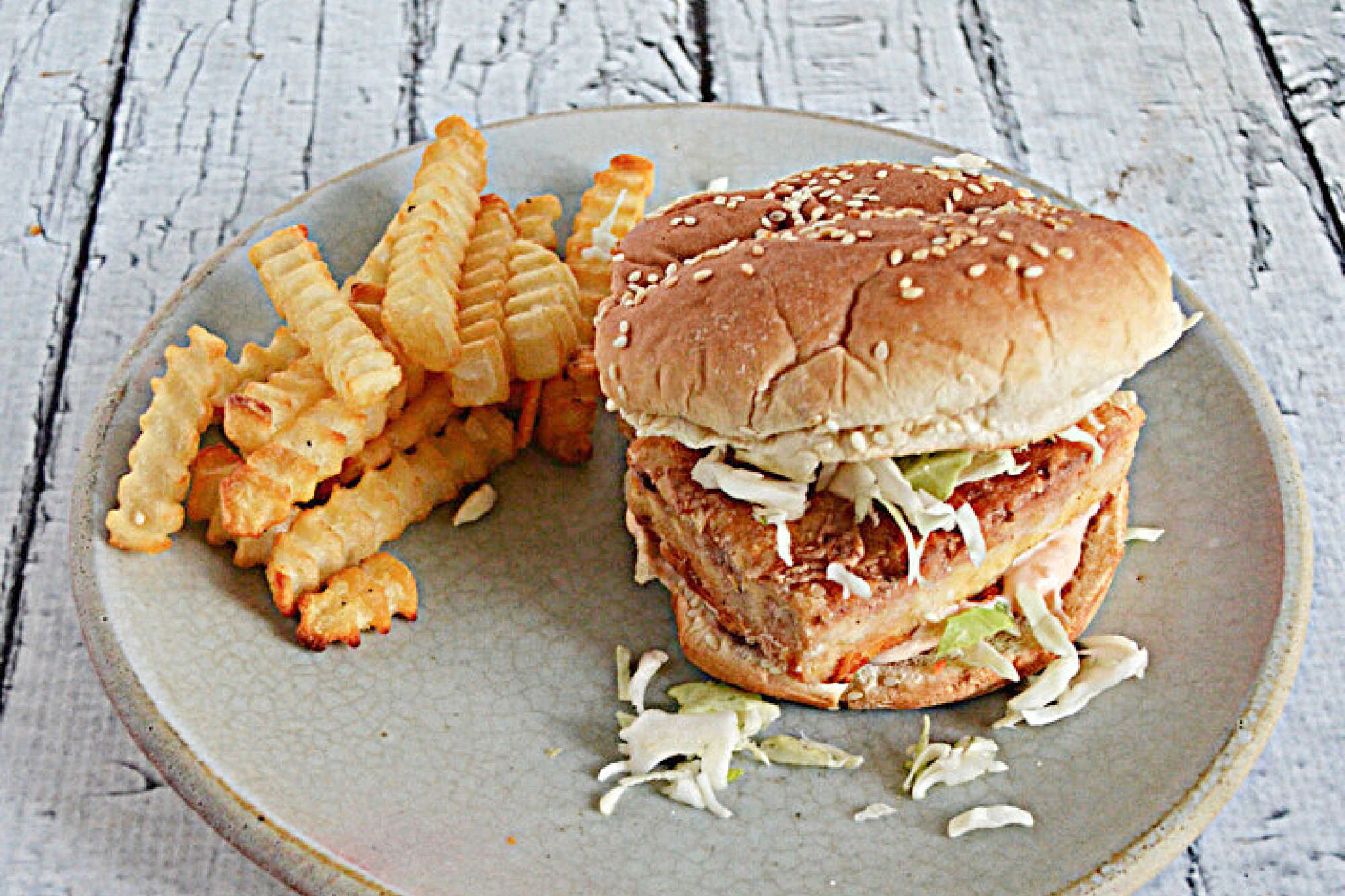 Fried Tofu Sandwiches are crispy fried tofu slab that are tangy and a touch spicy then served on a bun with spicy mayonnaise and shredded cabbage.