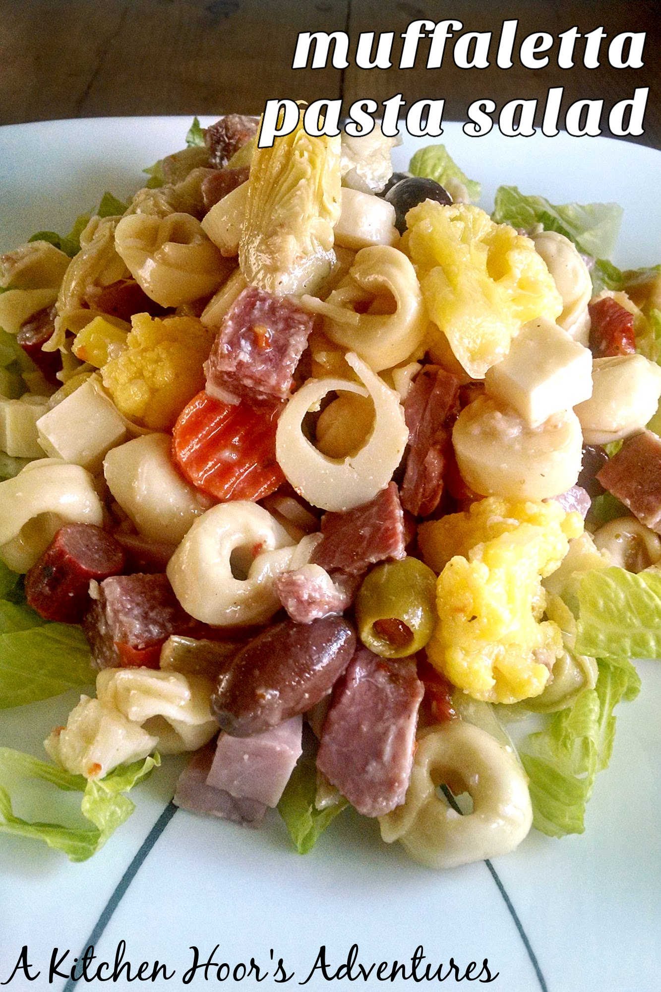 Looking for a crowd-pleasing dish to bring to your next BBQ? Look no further than this tasty Muffaletta Pasta Salad. Tangy, savory, and oh-so-easy to make. #BBQEssentials #MuffalettaPasta #SummerSideDish #FoodieFridays #MuffalettaLove #RecipeIdeas #MuffalettaPastaSalad #DeliciousDishes  #SummerVibes#MuffalettaPastaSalad #PastaSaladLovers #DeliciousDeliDish #FoodieFavs #SummerSides
