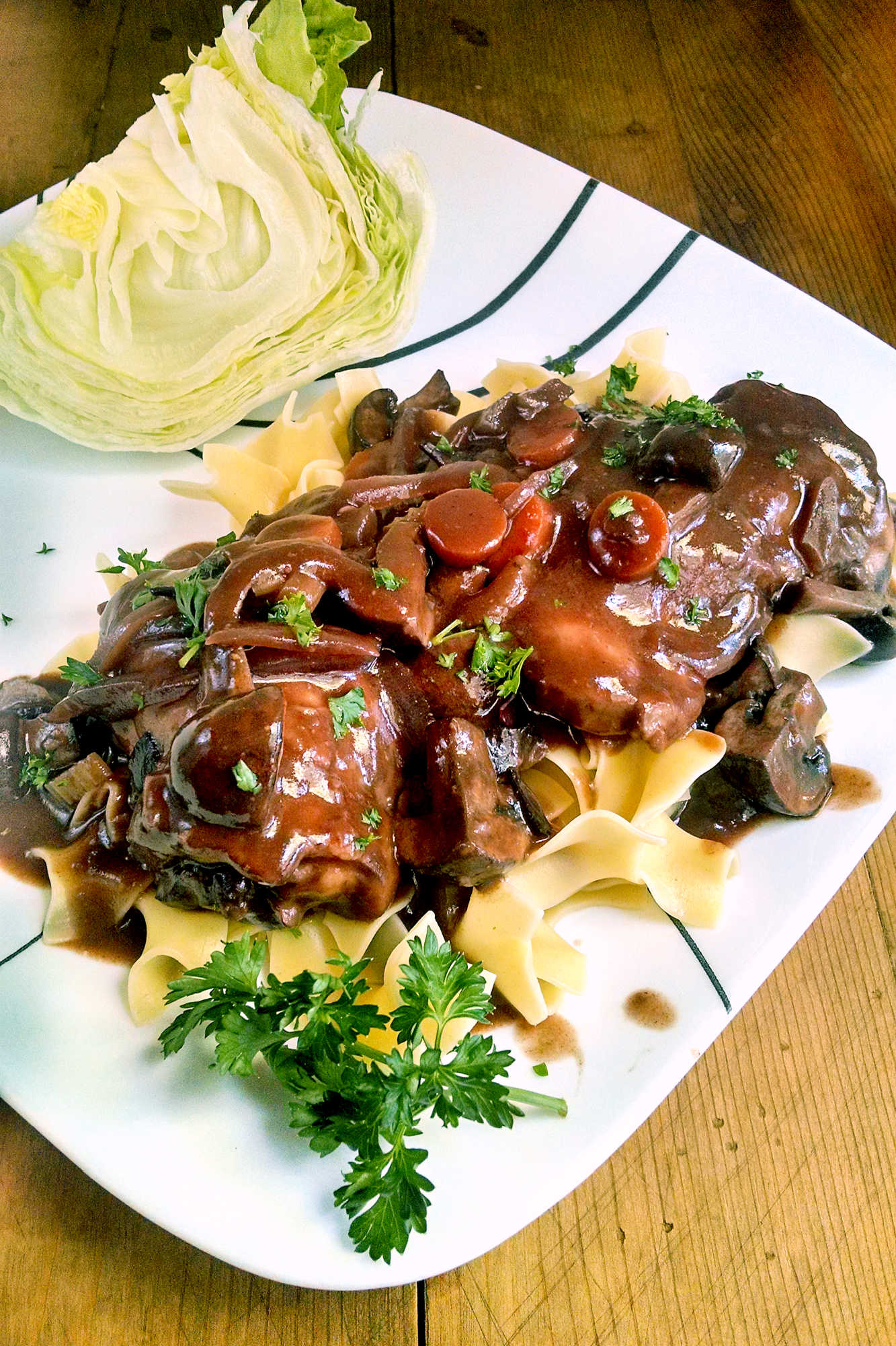 Coq au Vin is the ultimate French comfort food that will have you feeling like you're dining in a cozy bistro in Paris. Bon appétit! #coqauvinrecipe #frenchcuisineinspo #wineloverfavorites #dinnerpartydish #deliciousandfancy #FrenchCuisine #CoqauVin #ComfortFood