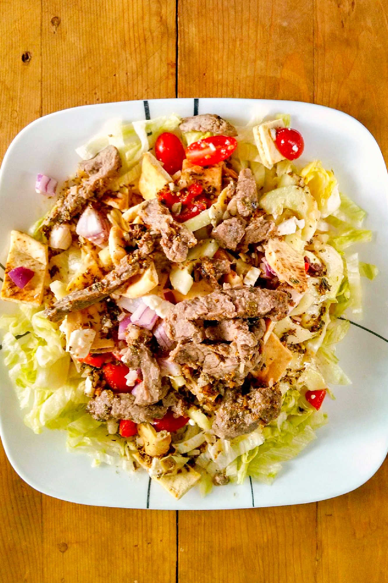 Spice up your salad game with a Pita Panzanella Salad with Steak! Juicy steak, fresh veggies, and a tangy dressing make for a mouthwatering meal. #PitaPanzanellaSalad #SteakSalad #HealthyEats #FoodieFavorites #CarnivoreCravings #SaladGoals #PitaPanzanella #SteakLovers #SaladLovers #MediterraneanEats #ForkAndKnifeDiaries