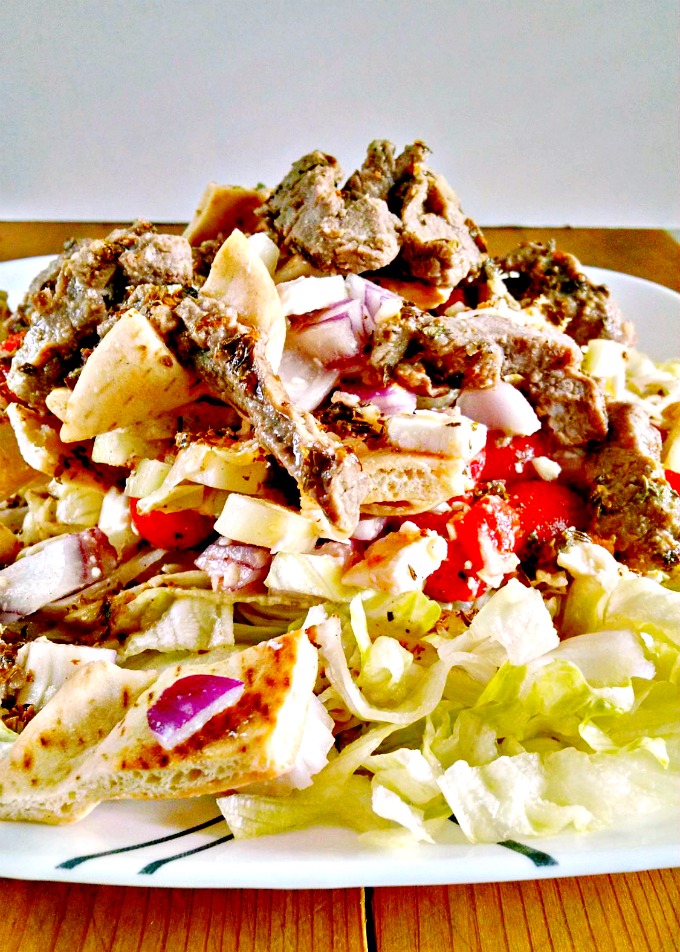 This Greek take on the Italian Bread Salad, Panzanella, uses toasted pita, cucumbers, red onions, and tomatoes as the base for this pre-cooked steak strips. Pita Panzanella Salad with Steak is a tasty and quick weeknight #EntreeSalad.