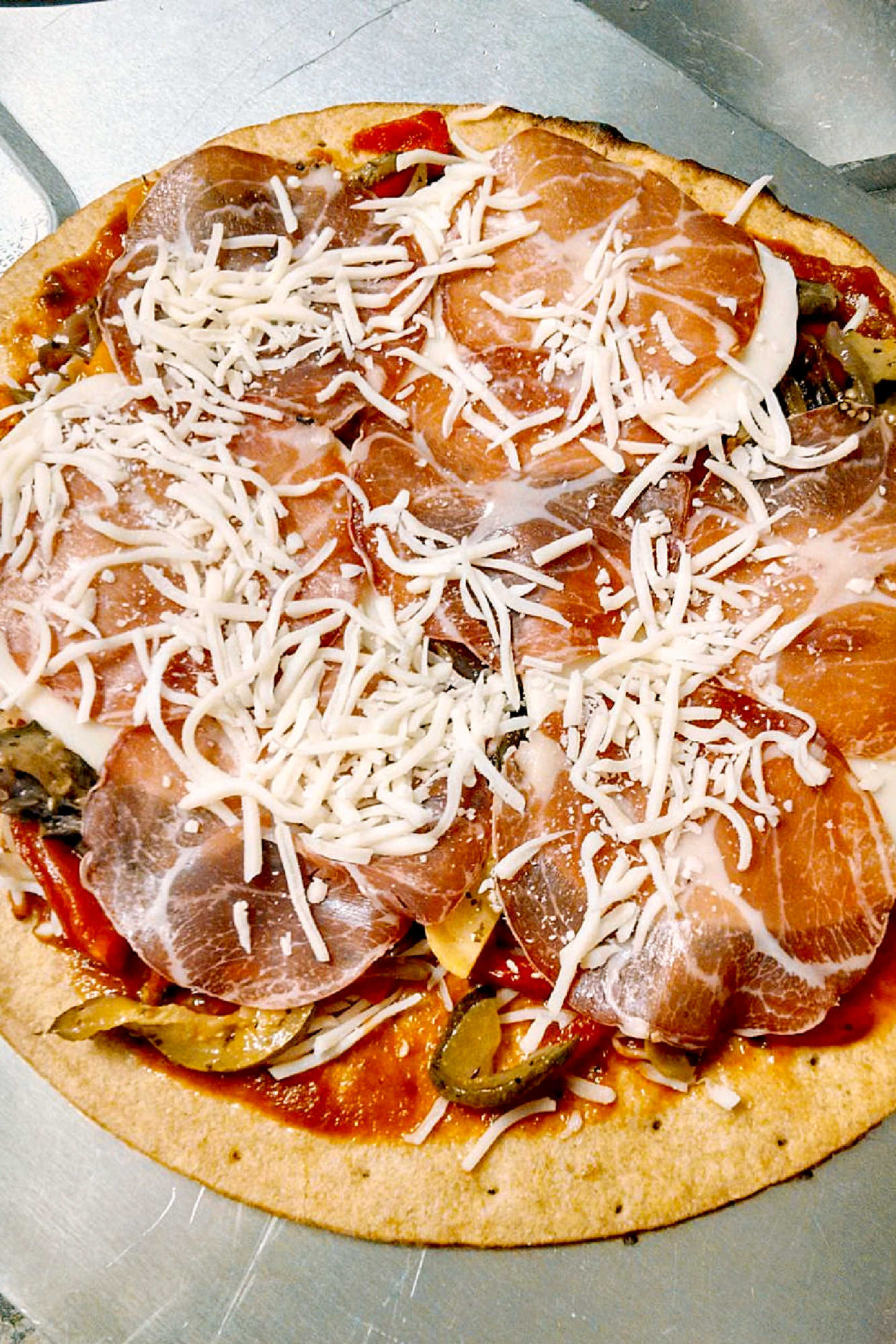 Looking for a flavorful and colorful pizza? Look no further than our Capicola Roasted Veggie Pizza! Savor the deliciousness of roasted veggies, savory capicola, and gooey cheese. #MeatlessMondayPizza #PizzaLoversUnite #PizzaCraze #PizzaLoversUnite #RoastedVeggieDelight #CapicolaCravings #FoodieFaves #InstaPizzaGuru