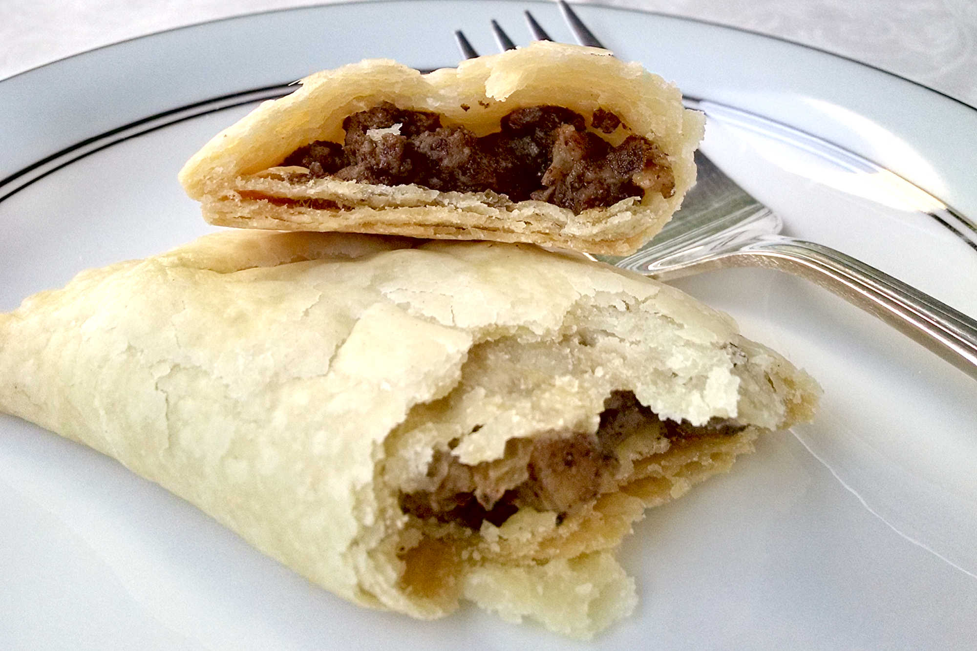 Spice up your snacking game with Curried Duck Mini Meat Pies - perfect for a party appetizer or a quick on-the-go snack! #MapleLeafFarmsDuck #duckpies #meatpies #CurriedDuckPies #SavoryHandpies
