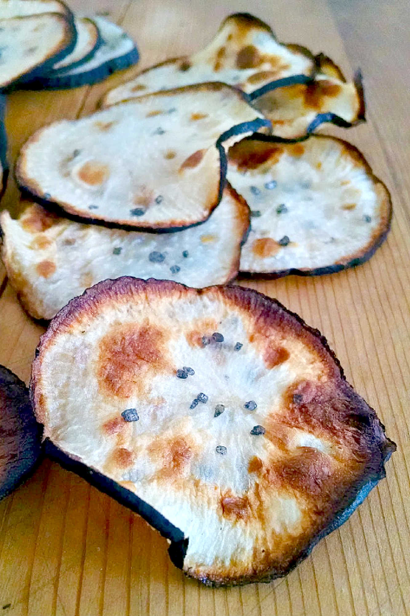 Spicy Black Radishes Chips are baked up into a crispy, delicious chip. If you can’t find black radishes, you could use daikon or any other large radish. Cooking times may vary with other types of radishes. #HealthySnacks #PlantBasedEats #SnackTimeSatisfaction #VeganChips #CrunchyDelight