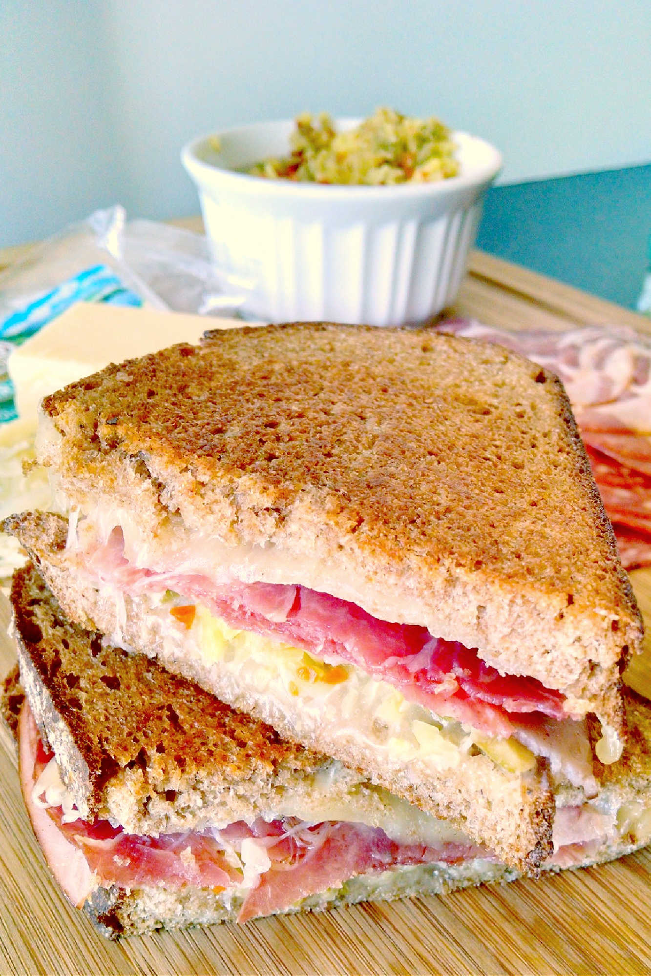 Indulge in cheesy goodness with this twist on a classic with this Muffuletta Grilled Cheese. Say goodbye to boring sandwiches! #GrilledCheeseMonth #grilledcheeseobsessed #cheeseplease #southerncomfortfood #foodiefinds #MuffulettaGrilledCheese #SandwichSensation #MeltedCheeseHeaven #NolaFoodieFaves #GourmetGrilledCheese