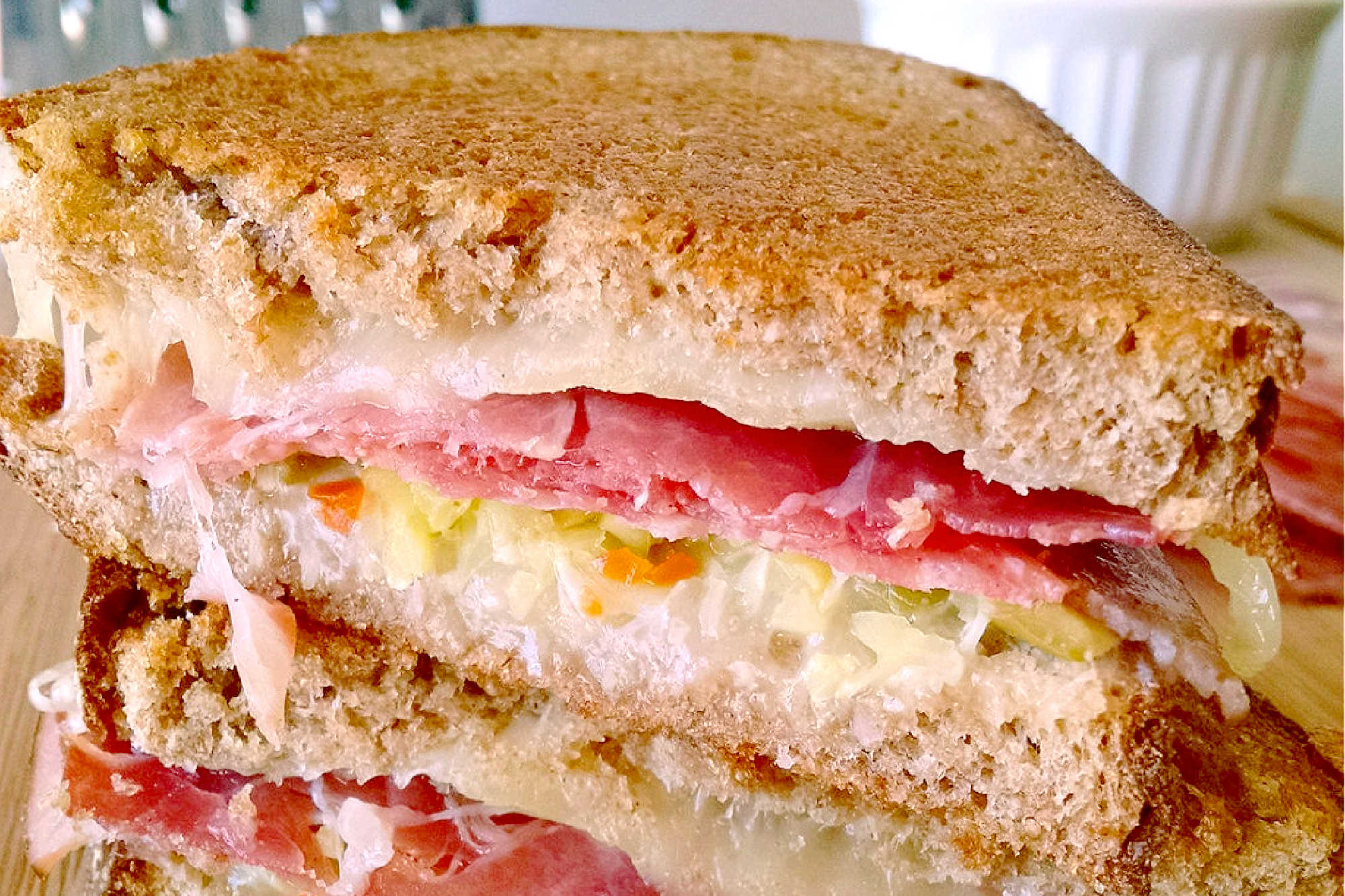 Indulge in cheesy goodness with this twist on a classic with this Muffuletta Grilled Cheese. Say goodbye to boring sandwiches! #GrilledCheeseMonth #grilledcheeseobsessed #cheeseplease #southerncomfortfood #foodiefinds #MuffulettaGrilledCheese #SandwichSensation #MeltedCheeseHeaven #NolaFoodieFaves #GourmetGrilledCheese