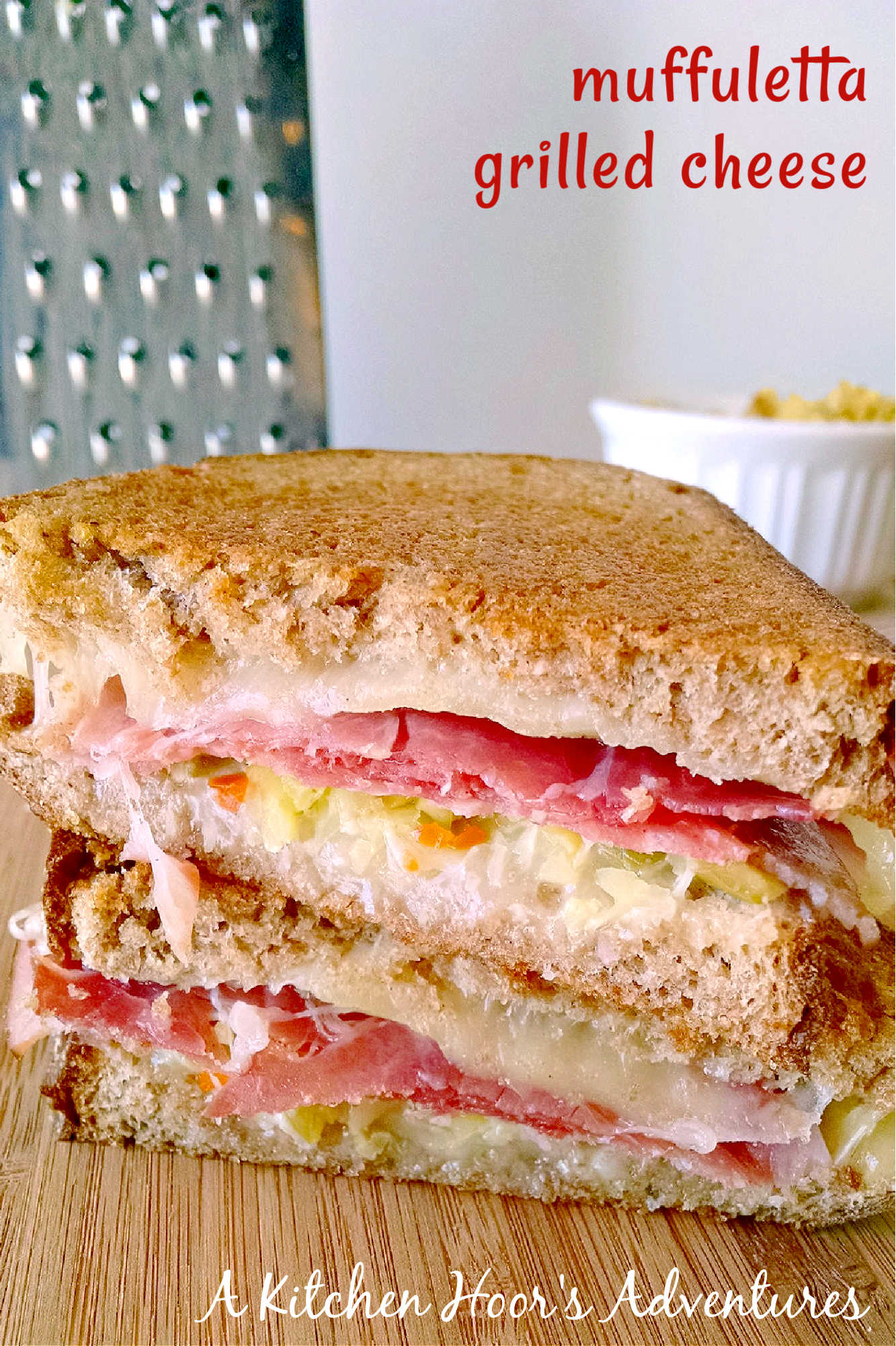 Indulge in cheesy goodness with this twist on a classic with this Muffuletta Grilled Cheese. Say goodbye to boring sandwiches! #GrilledCheeseMonth #grilledcheeseobsessed #cheeseplease #southerncomfortfood #foodiefinds #MuffulettaGrilledCheese #SandwichSensation #MeltedCheeseHeaven #NolaFoodieFaves #GourmetGrilledCheese