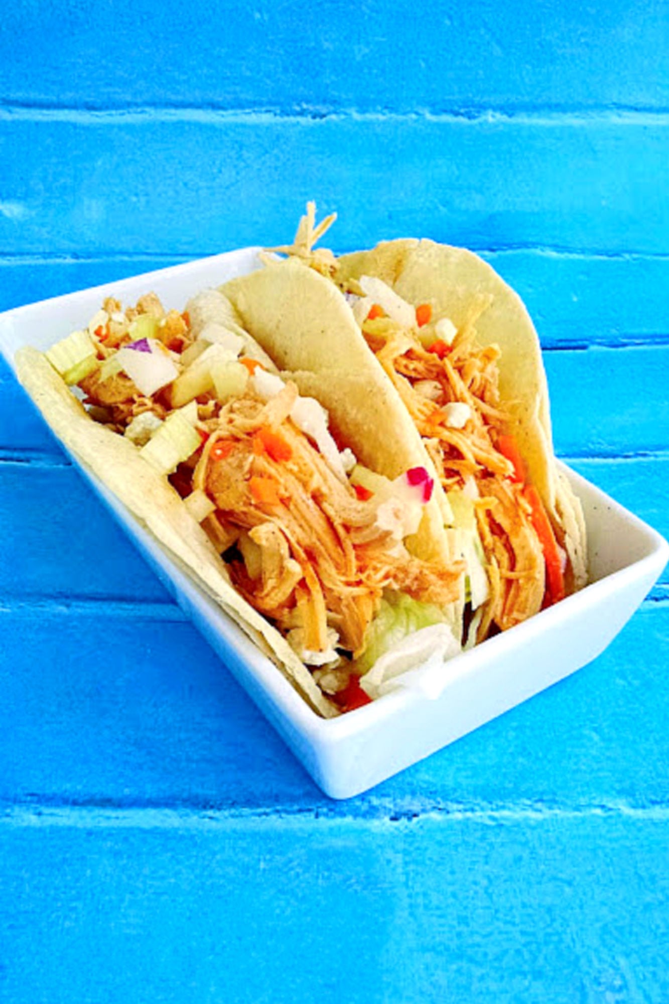 These Buffalo Chicken Tacos with Blue Cheese Radish Slaw will knock your taste buds off! And your family will want these ALL time. Don’t say I didn’t warn you! #OurFamilyTable #BuffaloChicken #chickentacos #bluecheeseslaw #radishslaw #slowcooker #BuffaloChickenTacos #TacoTuesday #GameDay