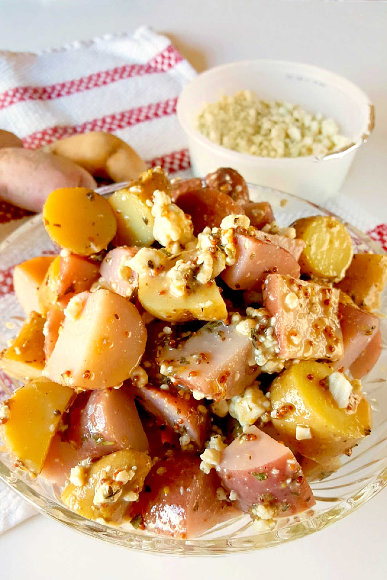 Forget the traditional mayo potato salad and try this irresistible Red White and Blue Cheese Potato Salad!  It will satisfy your #FourthofJuly cravings with creamy potatoes and tangy blue cheese. #potatosalad #bluecheese #vinaigrette #nomayopotatosalad