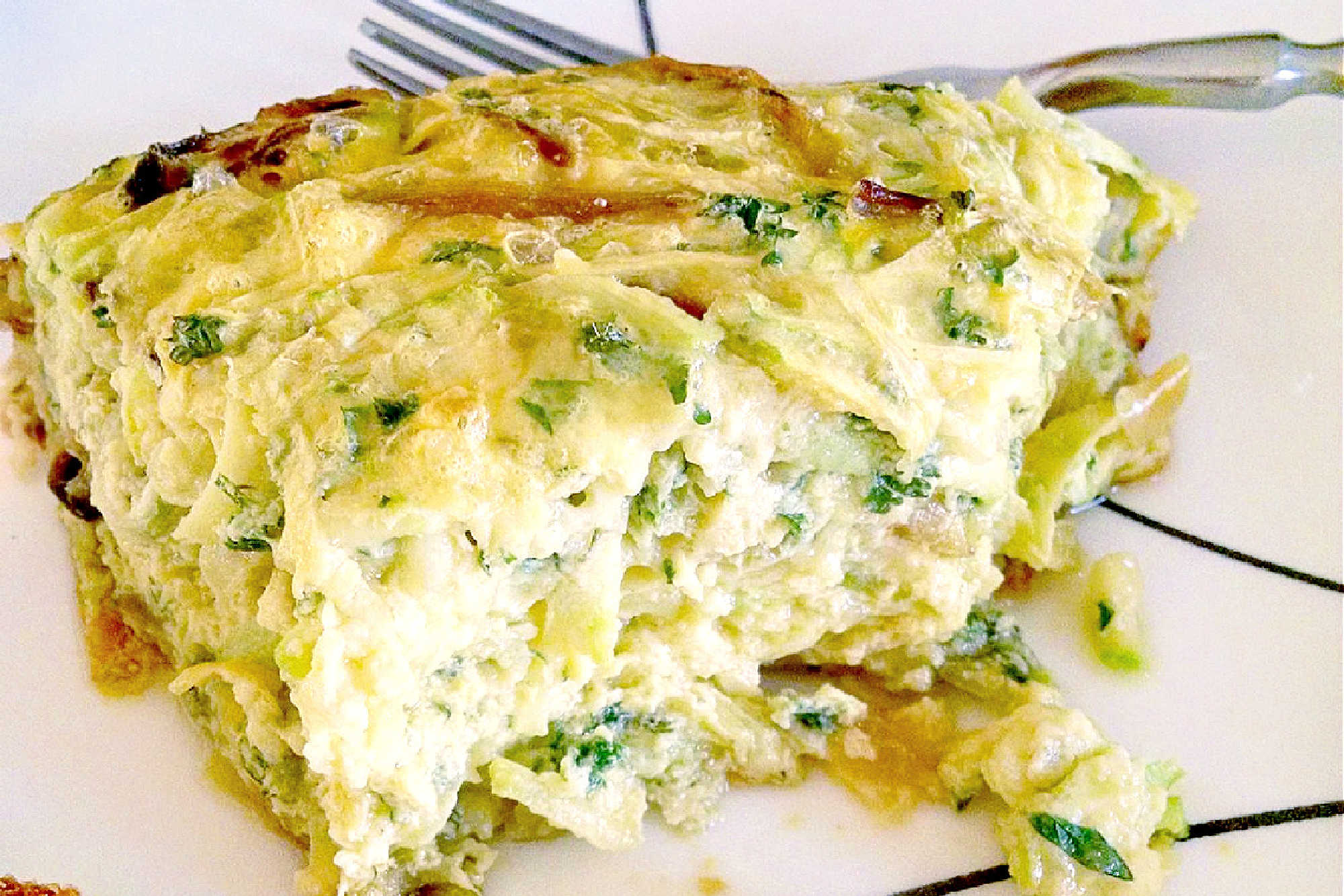 Looking for a delicious and unique brunch recipe? Try Persian Zucchini Frittata, also known as Kuku Kadoo! It's the perfect combination of savory flavors and easy to make. #PersianZucchiniFrittata #MiddleEasternBrunch #VegetarianEats #EasyFrittataRecipe #SummerBrunchIdeas #KukuKadoo #VegetarianEggDish #HealthyFusionFood