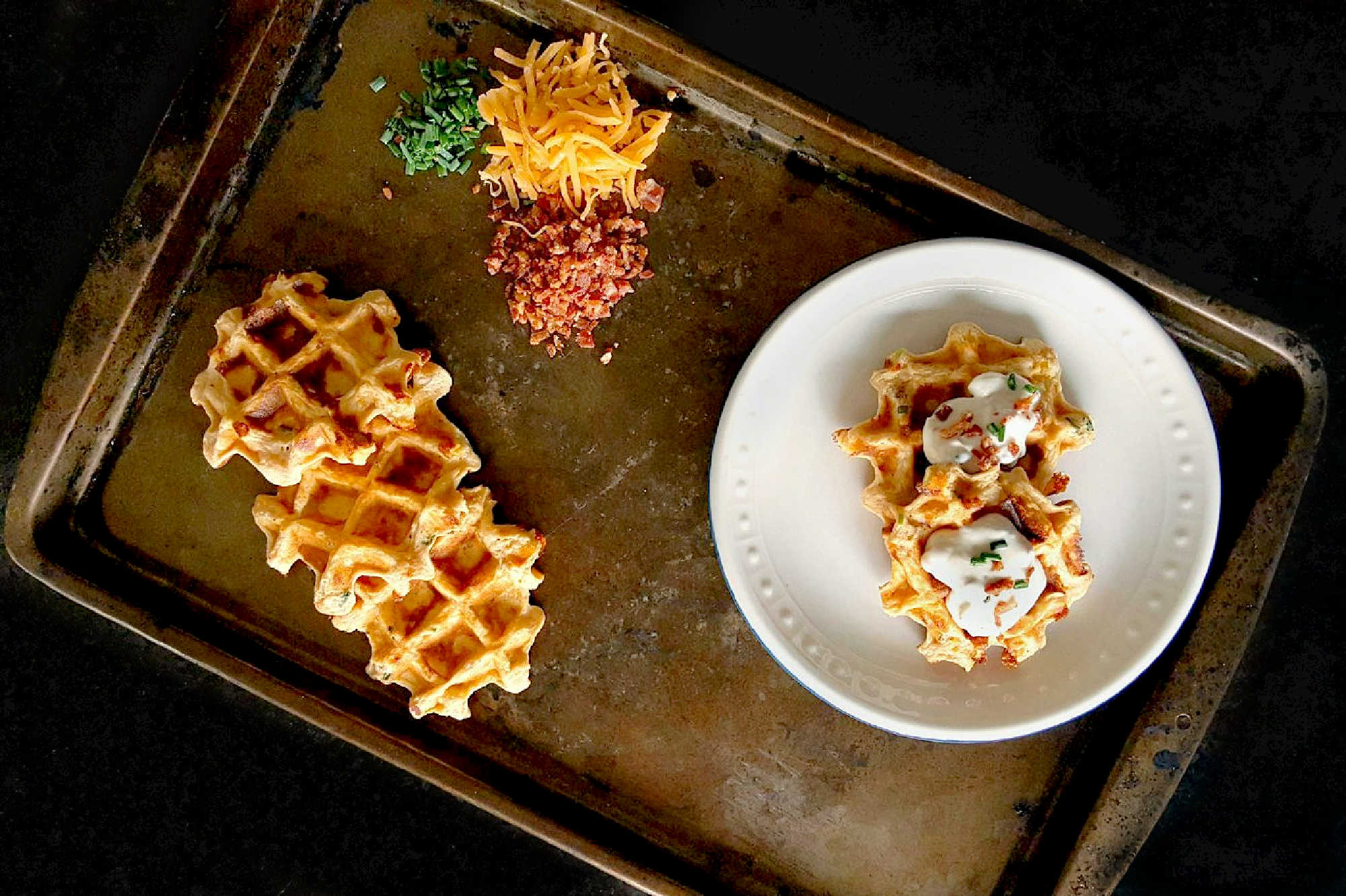 Say goodbye to boring potatoes and hello to these crispy, savory Waffled Twice Baked Potato Pancake Bites. Your taste buds will thank you. #twicebakedpotatopancakes #waffledpotatopancakes #potatopancakebites #brunchideas #savorywaffles