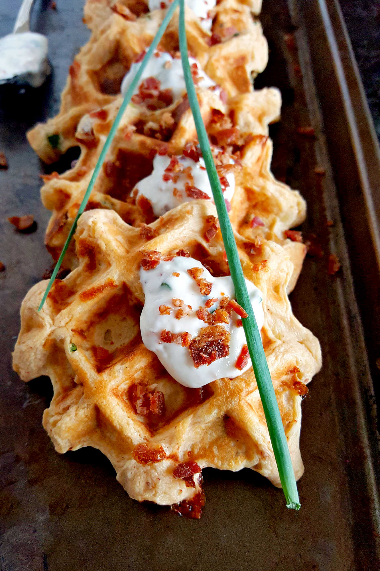 Say goodbye to boring potatoes and hello to these crispy, savory Waffled Twice Baked Potato Pancake Bites. Your taste buds will thank you. #twicebakedpotatopancakes #waffledpotatopancakes #potatopancakebites #brunchideas #savorywaffles