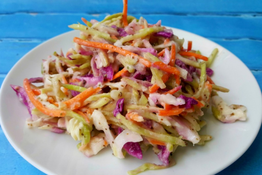 The hubs says this Kicked Up Coleslaw is the perfect recipe! It has the perfect amount of spice, sweet, and sour with the delicious crunch of broccoli slaw.