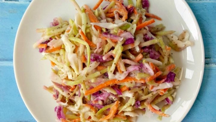 The hubs says this Kicked Up Coleslaw is the perfect recipe! It has the perfect amount of spice, sweet, and sour with the delicious crunch of broccoli slaw.
