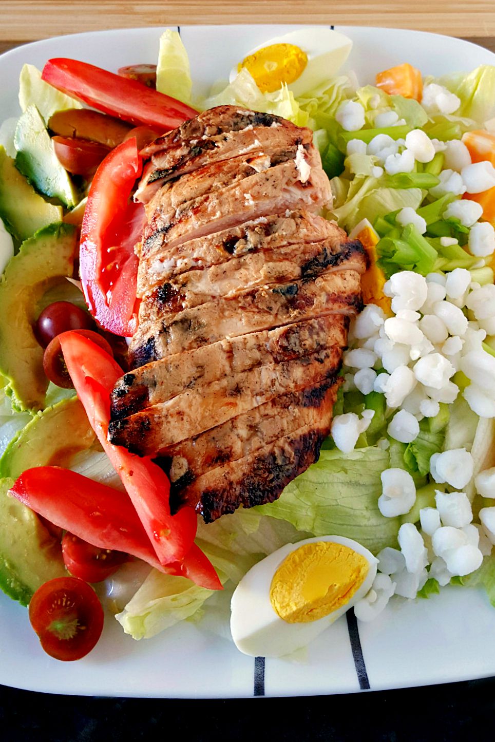 I basted chicken breasts in white barbecue sauce and grilled before slicing and topping this Alabama Cobb Salad. Don't let this white barbecue sauce fool you! It's got a kick!