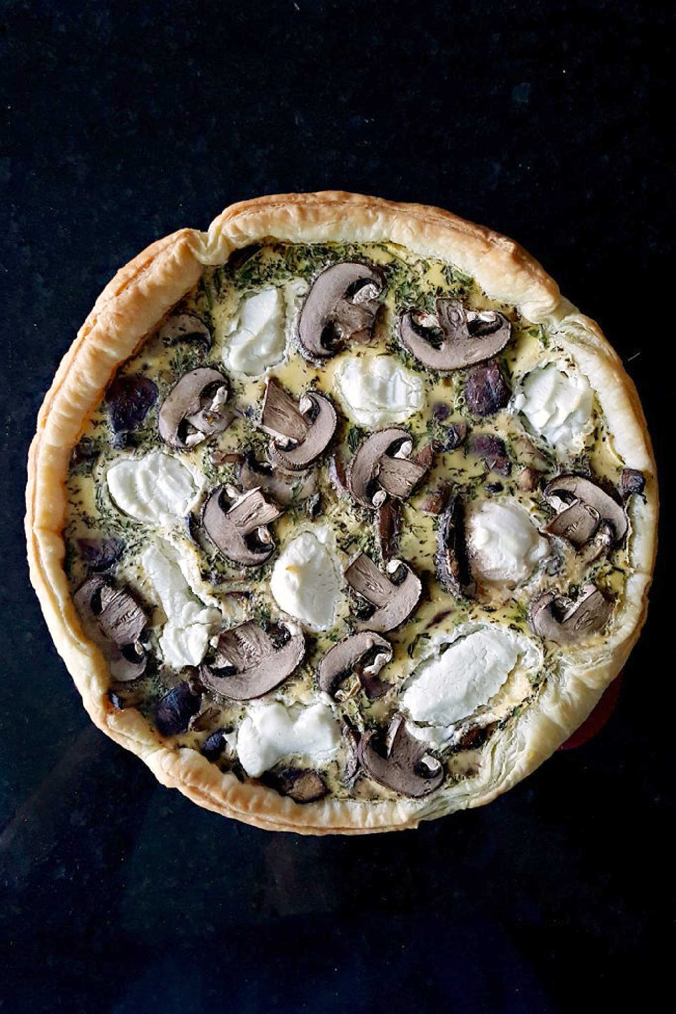 Searching for a flavorful centerpiece? These layers of flaky pastry, earthy mushrooms, and creamy goat cheese come together for a savory tart that's perfect for brunch or a light lunch. Save this recipe for your next meal inspiration. #MushroomCheeseTart #SavoryTart #GoatCheeseObsessed #MushroomLover #FarmToFork #mushroomtart #goatcheeselove #savorytreats #vegetariantart #gourmetfoodie