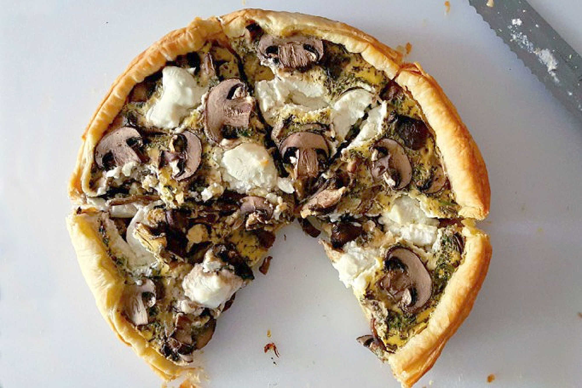 Searching for a flavorful centerpiece? These layers of flaky pastry, earthy mushrooms, and creamy goat cheese come together for a savory tart that's perfect for brunch or a light lunch. Save this recipe for your next meal inspiration. #MushroomCheeseTart #SavoryTart #GoatCheeseObsessed #MushroomLover #FarmToFork #mushroomtart #goatcheeselove #savorytreats #vegetariantart #gourmetfoodie