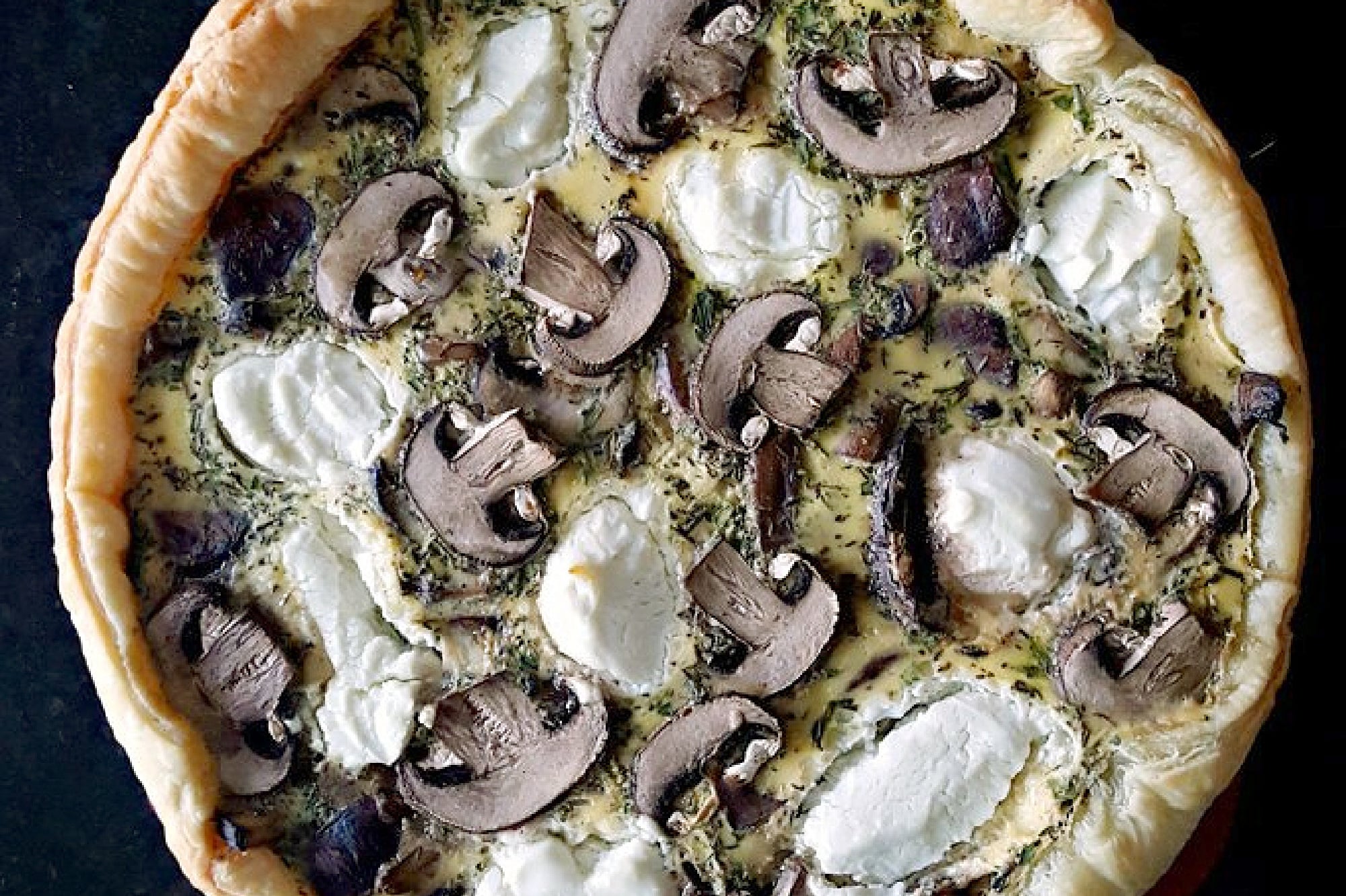 Searching for a flavorful centerpiece? These layers of flaky pastry, earthy mushrooms, and creamy goat cheese come together for a savory tart that's perfect for brunch or a light lunch. Save this recipe for your next meal inspiration. #MushroomCheeseTart #SavoryTart #GoatCheeseObsessed #MushroomLover #FarmToFork #mushroomtart #goatcheeselove #savorytreats #vegetariantart #gourmetfoodie