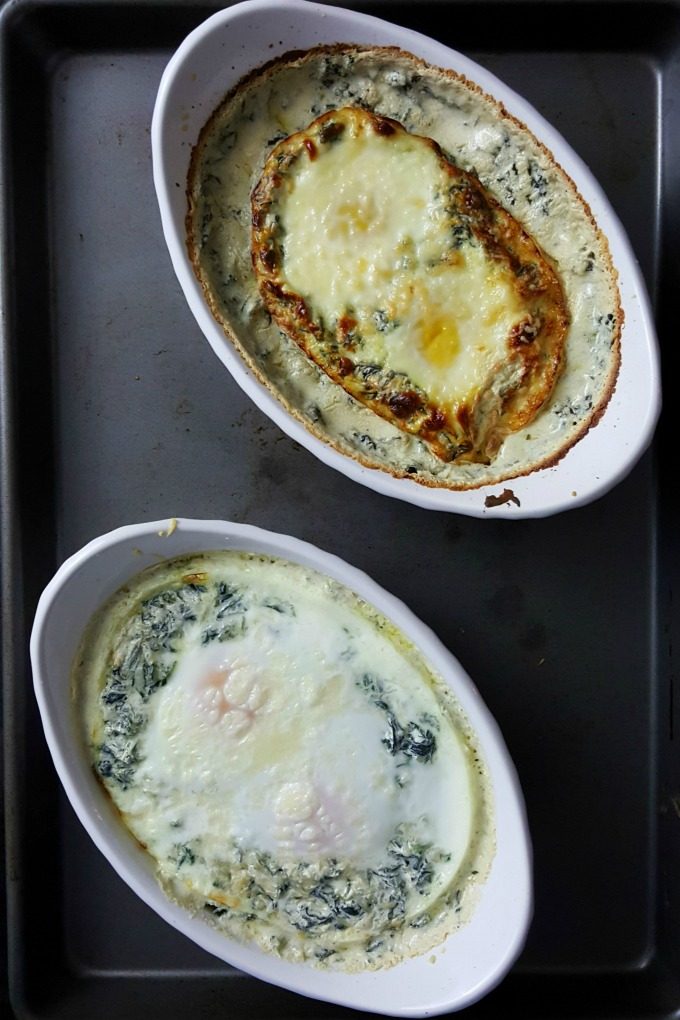 Spinach Baked Eggs may sound plain, but they're definitely are anything but that!  Eggs are baked in delicious and flavorful creamed spinach and topped with Parmesan cheese. Serve with garlic toast for a special brunch or #meatfree dinner.