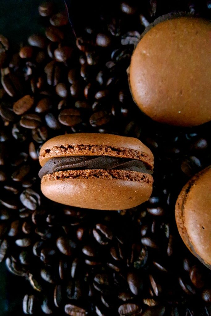 Get a coffee fix in these deliciously decadent macarons. Espresso Mocha Macaron with Salted Dark Chocolate Filling taste like a fancy cup of mocha espresso with a pleasant hint of salt in the buttercream.