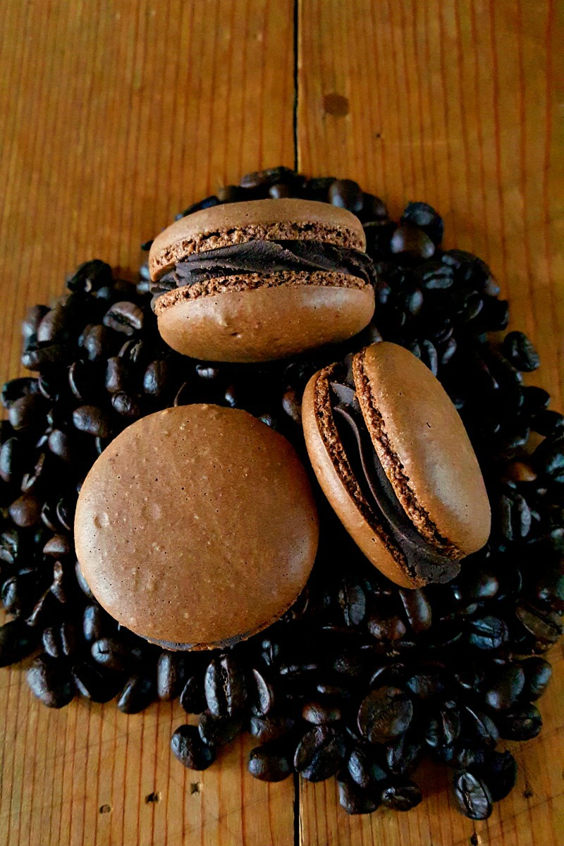 Get a coffee fix in these deliciously decadent macarons. Espresso Mocha Macaron with Salted Dark Chocolate Filling taste like a fancy cup of mocha espresso with a pleasant hint of salt in the buttercream.
