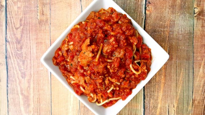 Marked down Italian sausage, 56 ounces of crushed tomatoes, and some herbs and spices make an amazing and simple bolognese style sauce. You will want to make this Slow Cooker Italian Sausage Bolognese repeatedly.