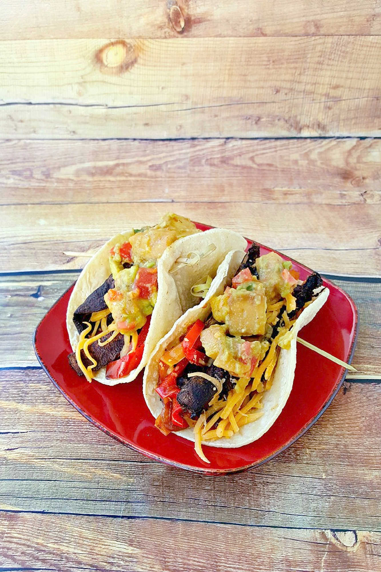 Sheet pan portobello fajitas bring bold flavors and easy clean-up to your table. Enjoy a savory mix of roasted veggies and mushrooms ready in one simple step.  #sheetpanfajitas #portobellos #plantbasedeats #easydinnerideas #weeknightmeals