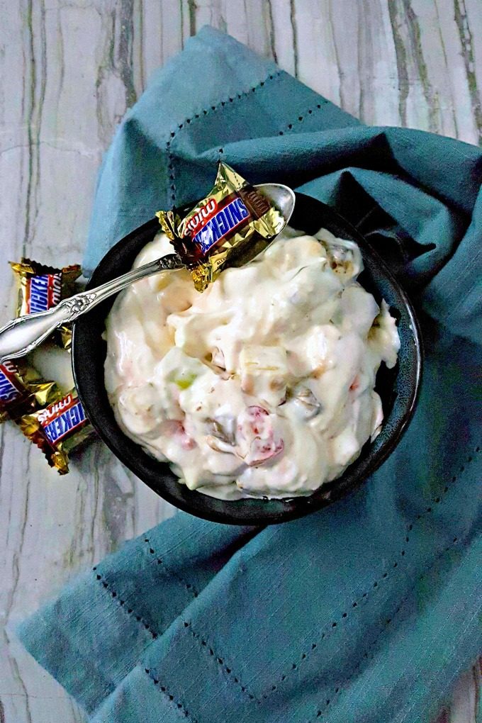 I'm sure your kids won't mind sharing their candy with you when you make this Snickapplebutterway Salad. It tastes like cheesecake fluff with crunch apples and pieces of Halloween candy. #SundaySupper