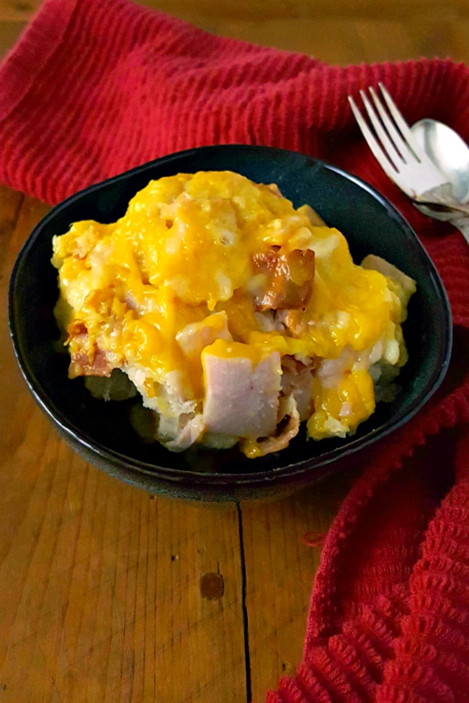 Biscuits mingle with leftover turkey and bacon swimming in a cheese sauce topped with cheese. Bubble Up Hot Brown Casserole is simply delicious and can be served any time after your food coma. #SundaySupper