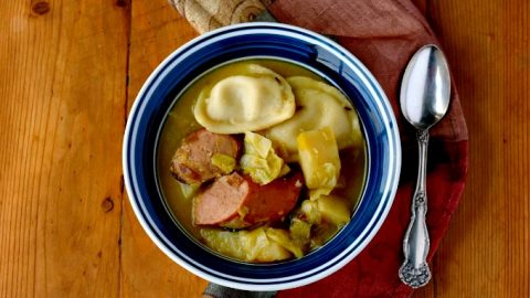 An Irish coddle is a dish with pork sausage and rashers cooked with potatoes and onions as a stew or soup. My Polish Coddle uses kielbasa, potatoes, and onions topped it with mini pierogies.