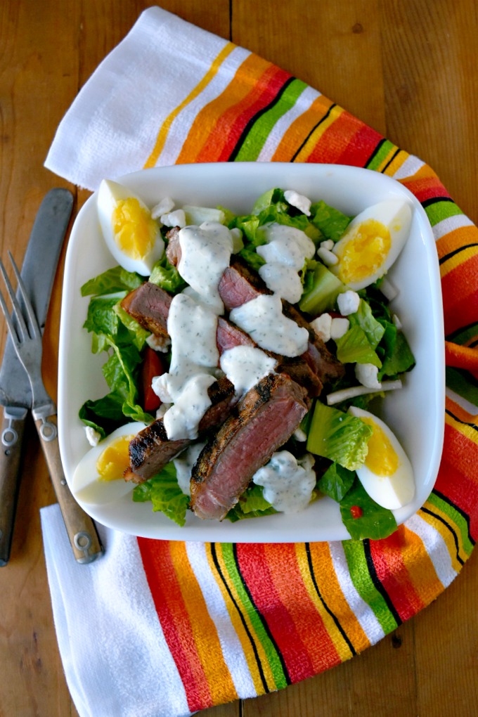 This Grilled Greek Steak Salad with Greek Goddess Dressing is full of delicious oregano, garlic, and rosemary flavors, delicious steak, and cool salad. Perfect for summer! #SundaySupper