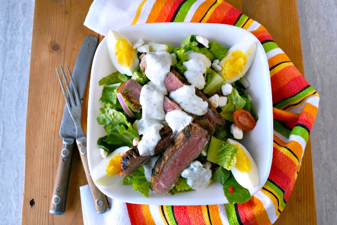 This Grilled Greek Steak Salad with Greek Goddess Dressing is full of delicious oregano, garlic, and rosemary flavors, delicious steak, and cool salad. Perfect for summer! #SundaySupper