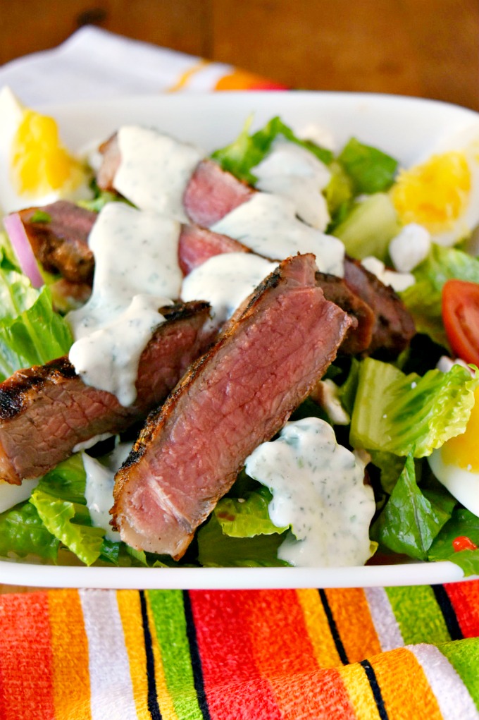 This Grilled Greek Steak Salad with Greek Goddess Dressing is full of delicious oregano, garlic, and rosemary flavors, delicious steak, and cool salad. Perfect for summer! #SundaySupper