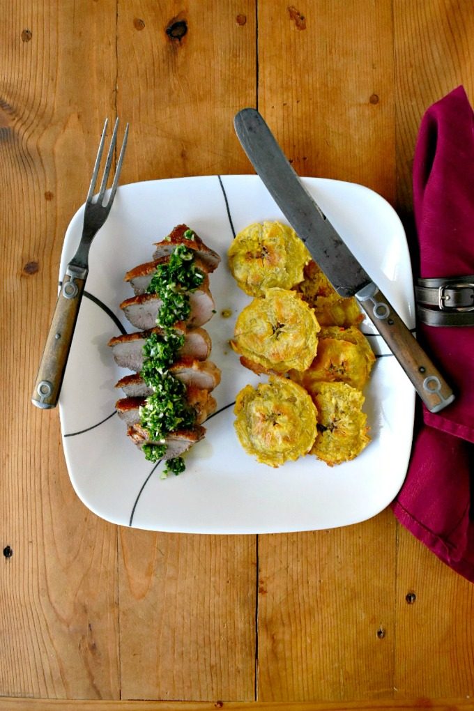 Chimichurri Crispy Duck with Baked Tostones is not your typical duck breast recipe! The skin is crispy, the chimichurri is delicious and the baked tostones round out the Latin American meal. Chimichurri Crispy Duck with Baked Tostones